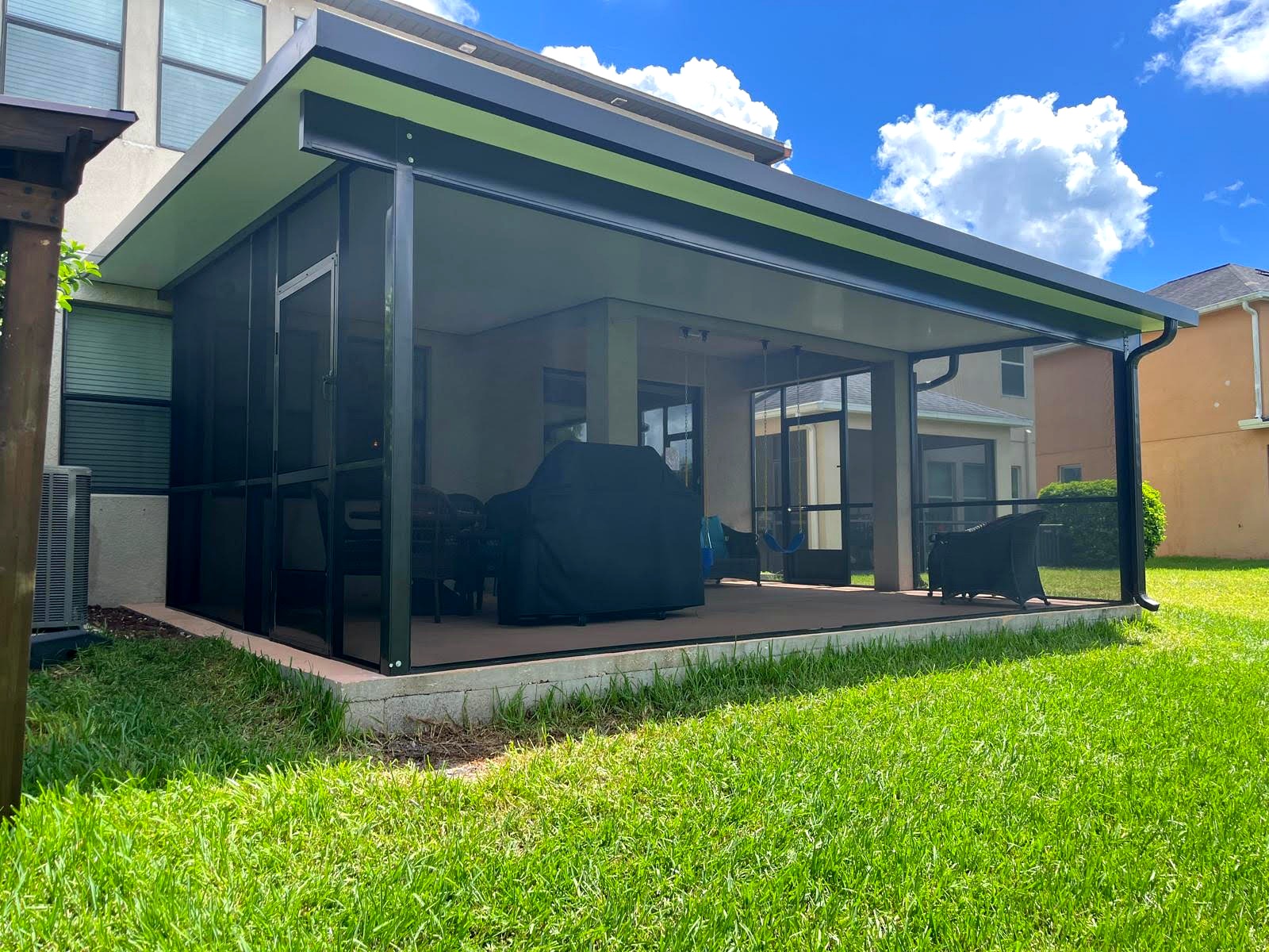 Modern two-tone patio cover with screen room — Land O Lakes, FL