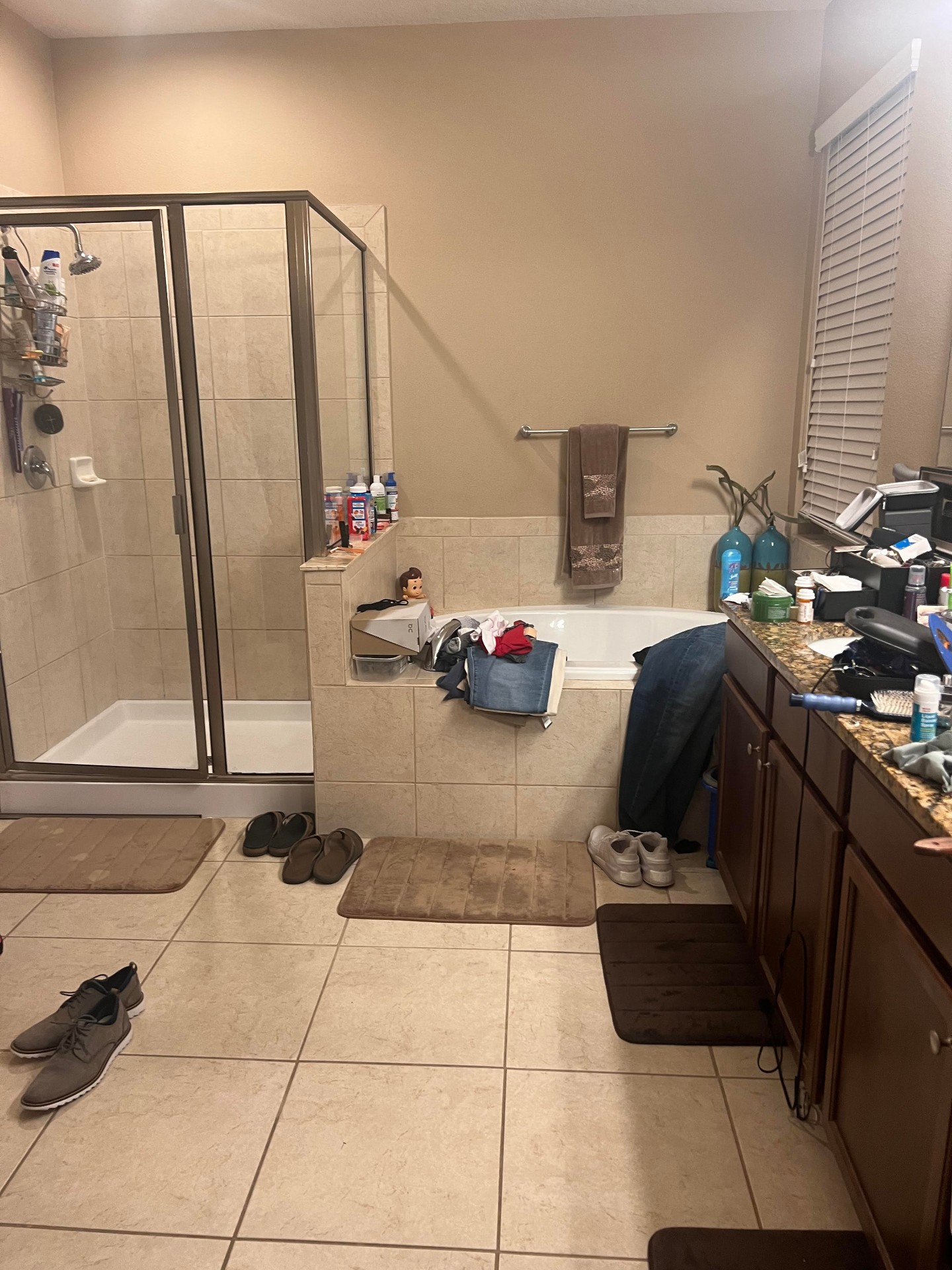 Original dated bathroom with framed shower and garden tub before remodel
