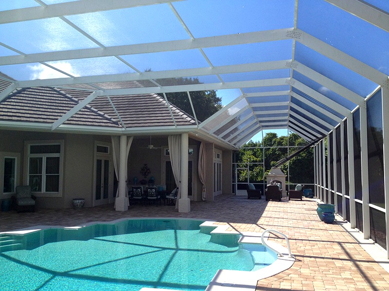 White mansard pool enclosure with paver deck — Tampa Bay, FL